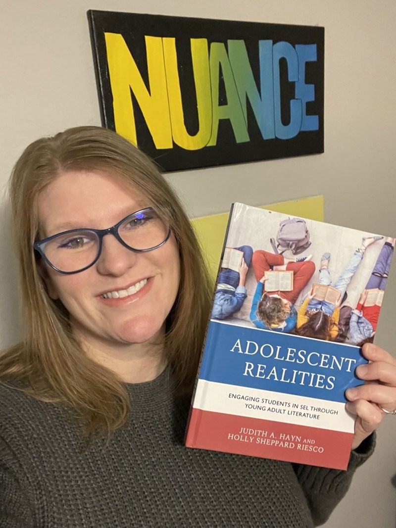 Holly Sheppard Riesco with her new book, Adolescent Realities: Engaging Students in SEL through Young Adult Literature.