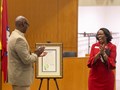 Chancellor Charles Robinson and Dean Cynthia Nance of the School of Law unveil proclamations from Arkansas Gov. Sarah Sanders and Fayetteville Mayor Lioneld Jordan as the start of the law school's centennial year.