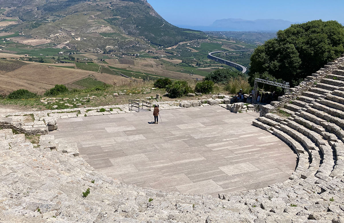 doctoral student Mitchell Simpson sets up a 360-degree camera in the ancient theater at Segesta Sicily