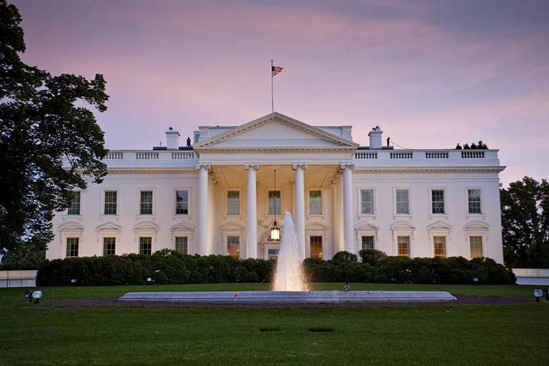 A photo of the White House at dusk.