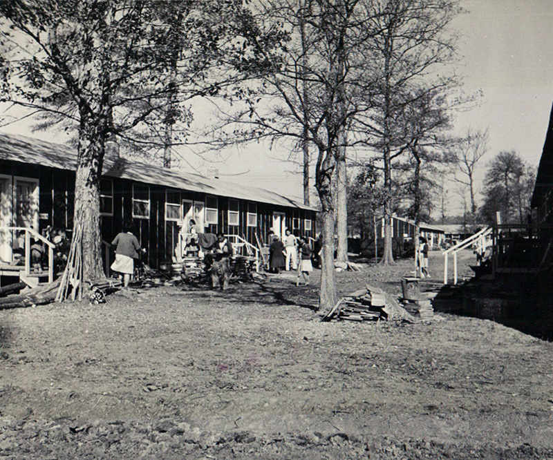 A street scene on an uneventful afternoon in block 7 of the Jerome Relocation Center in Denson, Arkansas.