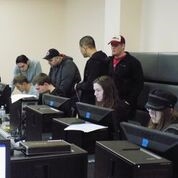 Photo of students on University of Arkansas cyber security team working at computers.