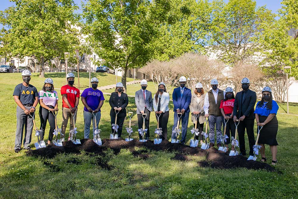 Students and administrators use shovels to break ground for the NGPC gardens