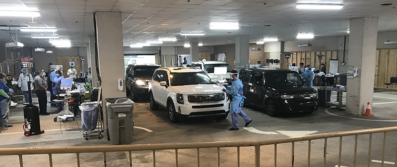 Medical staff working in a drive-through testing center at UAMS
