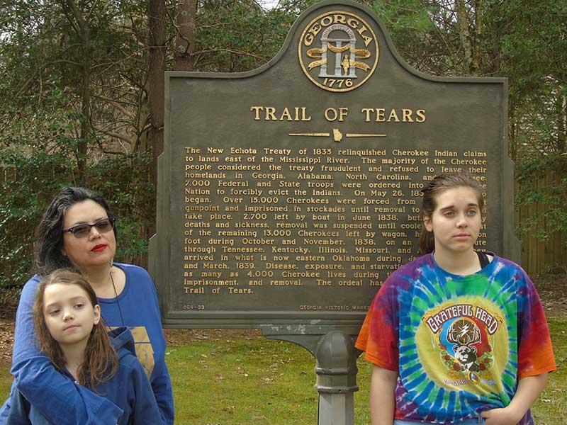 Andrea Rogers and her daughters at a historic marker at New Echota