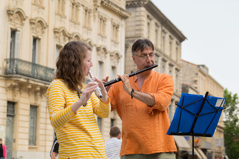 Nikola Radan and Chelsea Hodge play flute in a European city