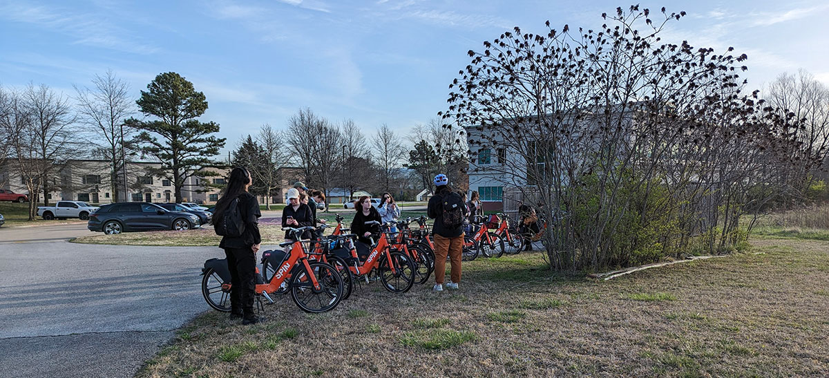 art students arrive at the remnant prairie on Spin electric bicycles