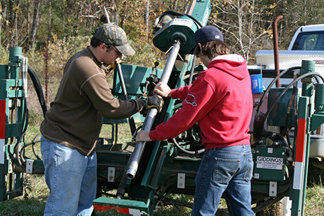 Members of the Big Creek Research and Extension Team work with a soil probe to extract a soil core for nutrient and physical analysis on a permitted manure application field. (U of Arkansas System Division of Agriculture photo).