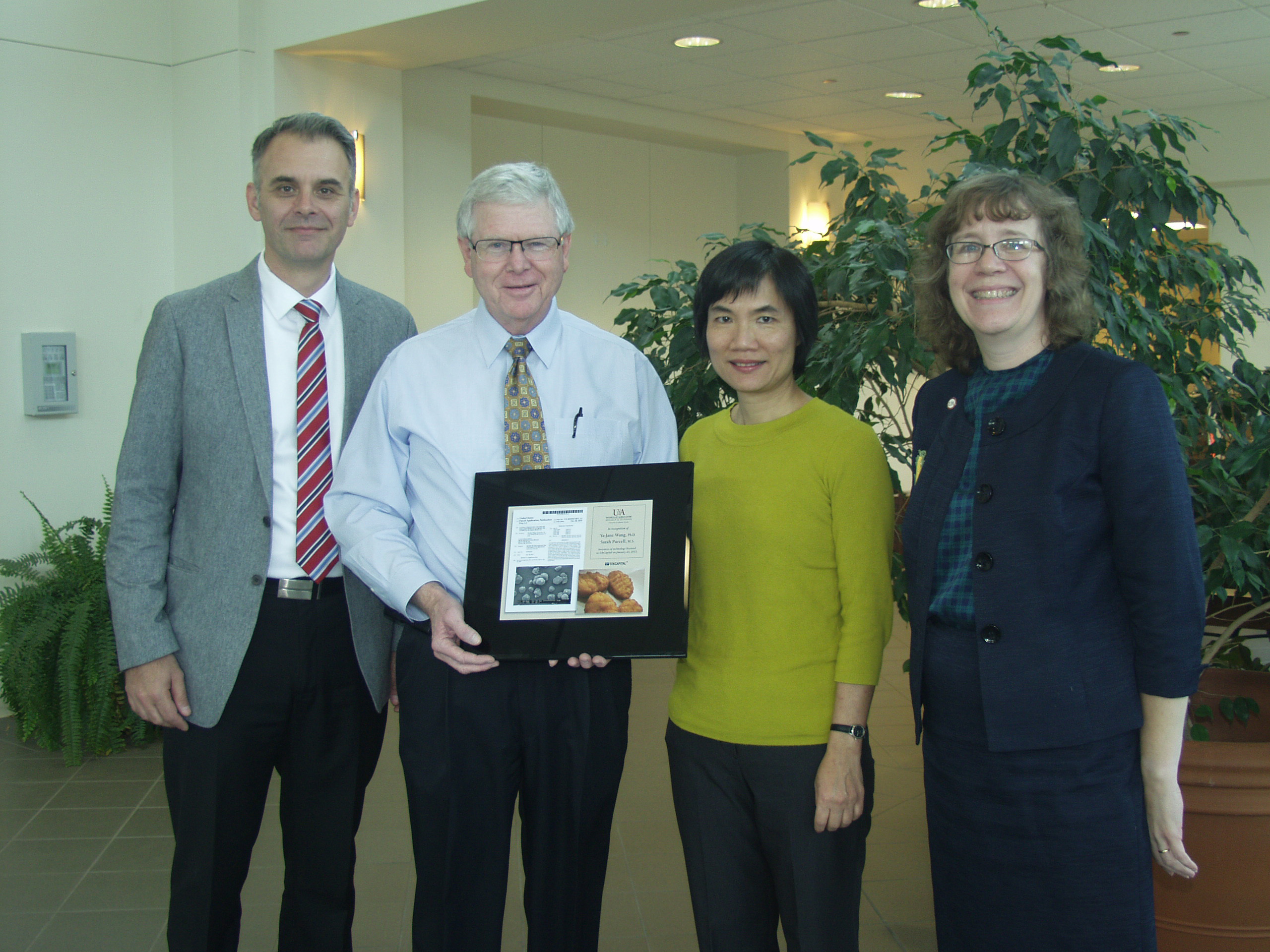 Professor Ya-Jane Wang (third from left) is recognized for her research with (from left) Jean-Francois Meullenet, head, Food Science; Mark Cochran, vice president for agriculture, and Lisa Childs, assistant vice president for technology commercialization.