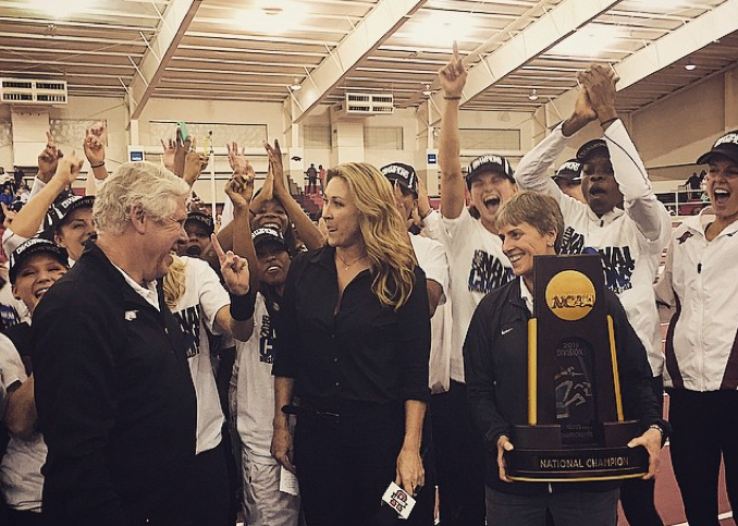 Coach Lance Harter and the women's track and field team receive the National Champions trophy Saturday.