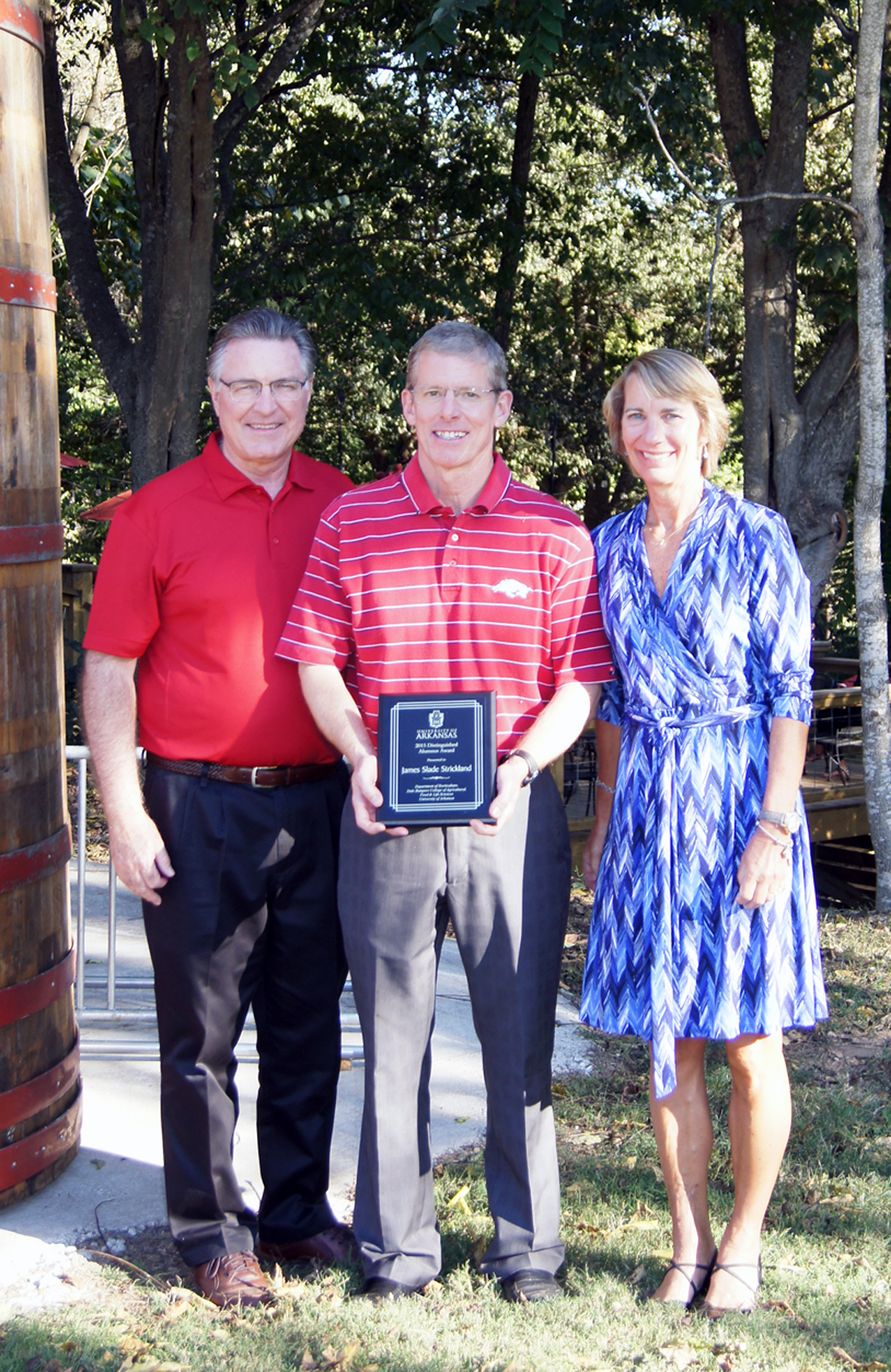 Slade Strickland, center, and his wife Elizabeth accept the 2015-16 Horticulture Department Distinguished Alumnus Award from department head Wayne Mackay. 