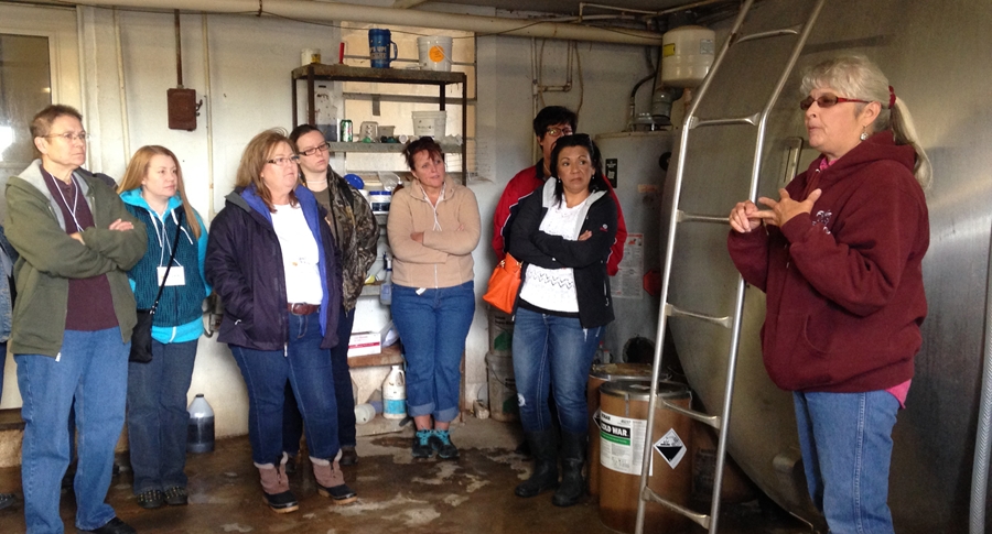 Susan Anglin, of Triple A Farms, explains the milk collection process to the Moms on the Farm tourists.