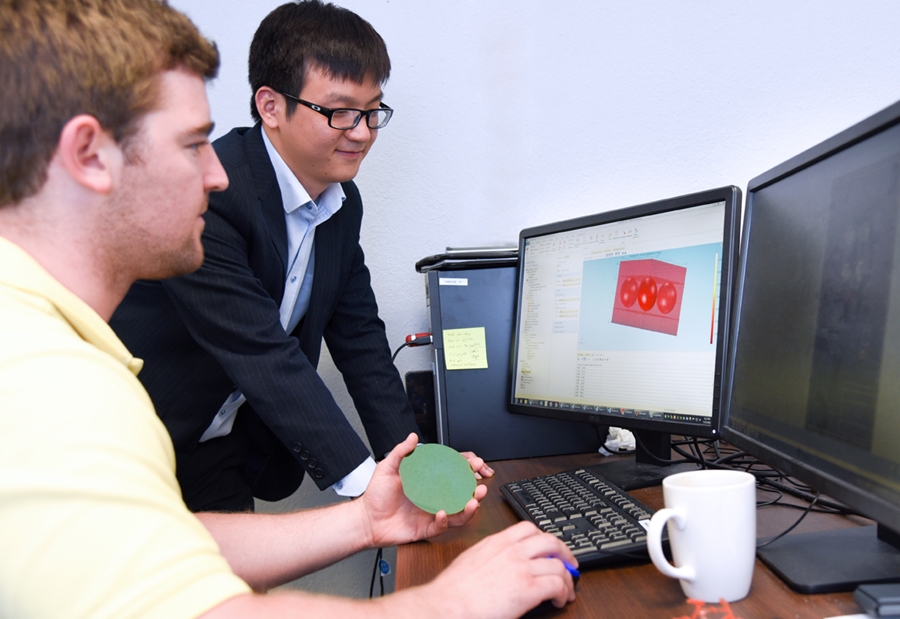 Wenchao Zhou and graduate student Austin Van Horn are researching ways to improve the speed of 3D printers.