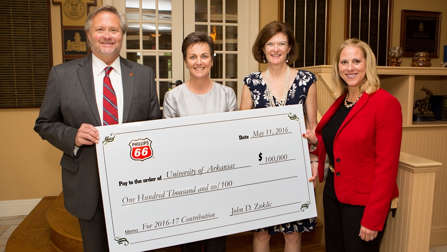 Dean John English, Associate Dean Anne O'Leary-Kelly and Assistant Vice Chancellor for Development Katy Nelson-Ginder accept a check from Phillips 66 during their recent campus visit.