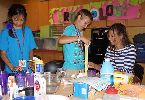 Kolt Burton and his mother, Tonya Landrum, work together in the grossology class at Young Scholars.