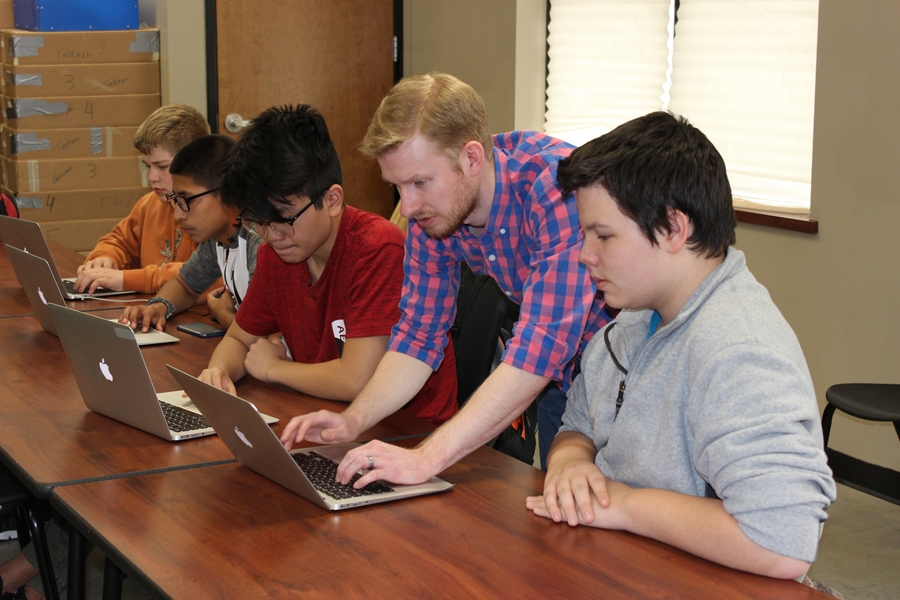 Jared Justus of Rockfish Digital assists Lincoln High School Students with a computer programming assignment.