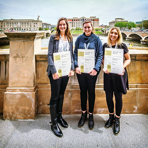 Hannah Moll, Erin Cox and Jordan Pitts show off the awards they received from the Central States Region of the American Society of Landscape Architects, during the conference in Des Moines, Iowa, in April.