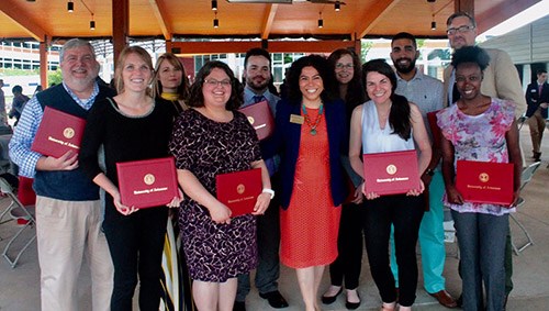 Graduates of the Arkansas Teacher Corps program celebrate the completion of their Fellowship with Mireya Reith, center, chair of the Arkansas State Board of Education.