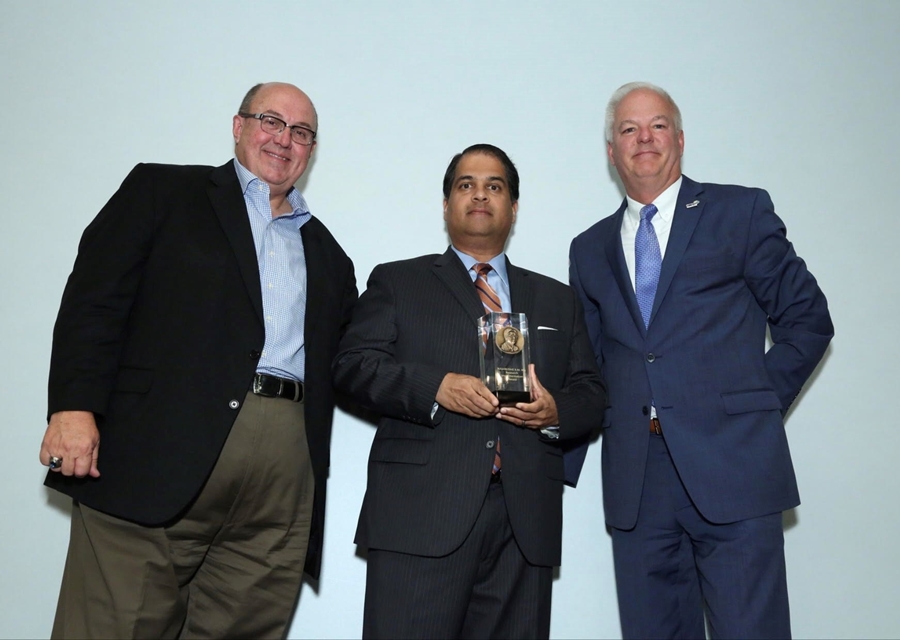 Winner of the 2017 S.M. Wu Research Implementation Award, Ajay Malshe, is congratulated by Dean Bartles and Jeff Krause, CEO of the Society of Manufacturing Engineering.