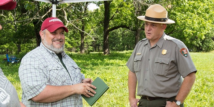 Jamie Brandon, station archeologist at Fayetteville, talks with Kevin Eads, superintendent of the Pea Ridge National Military Park during archeological work at the Civil War site.