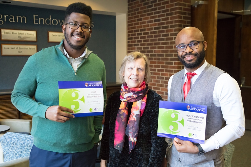 Patricia Koski, associate dean for the Graduate School and International Education (center), presents Malachi Nicholas (left) and Edidiong Udofia with their Three Minute Thesis award certificates.