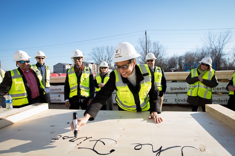 Carolyn Henderson Allen, dean of Libraries, signs the first cross-laminated timber panel installed in Arkansas.