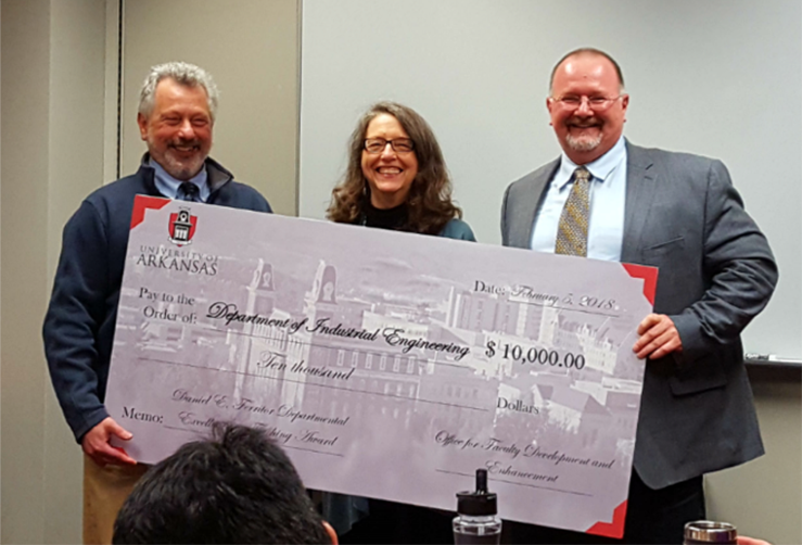 From left, Provost Jim Coleman and Jeannie Whayne, chair of the Ferritor Award Review Committee, present a $10,000 department award to Ed Pohl, head of the Department of Industrial Engineering.