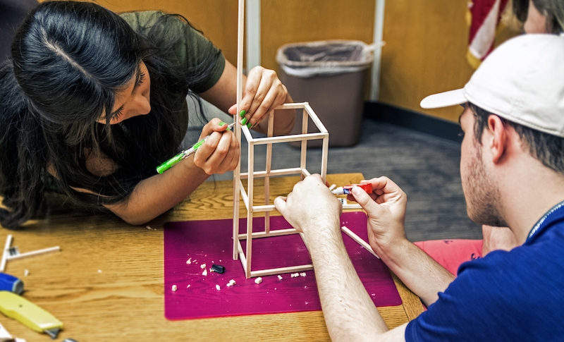 Engineering Summer Academy participants build balsa wood towers as part of the "Structure and Function" track.