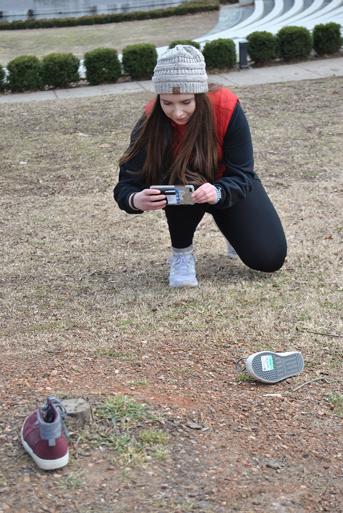 Kyra Vreeland, an architecture student, photographs a pair of shoes as part of the design thinking workshop for honors students, led by Beth Tauke and held in February on the U of A campus.