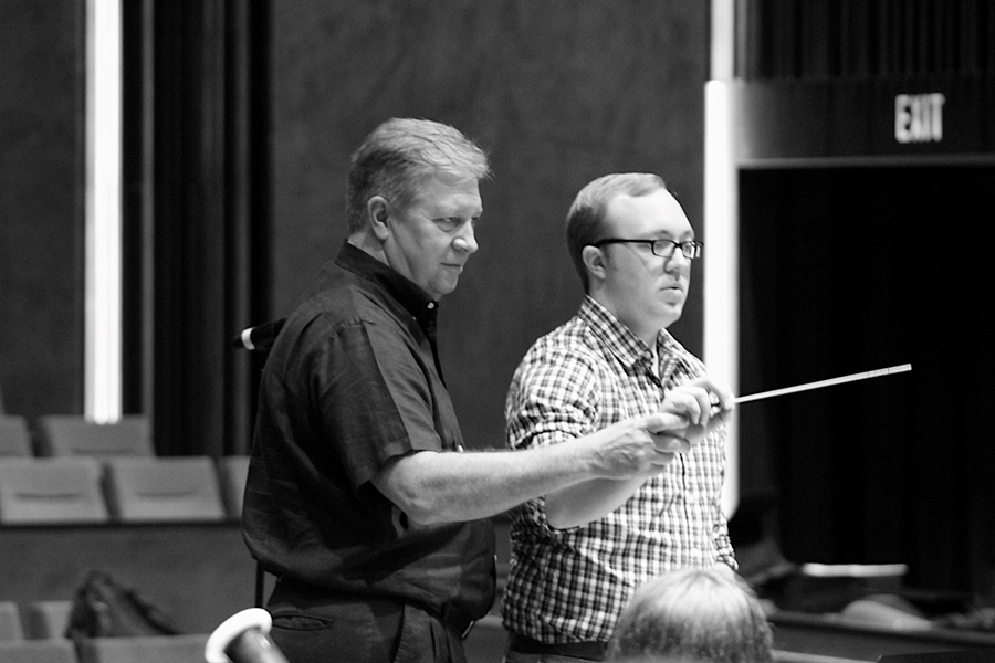 Christopher Knighten works with a University of Arkansas Conducting Symposium participant