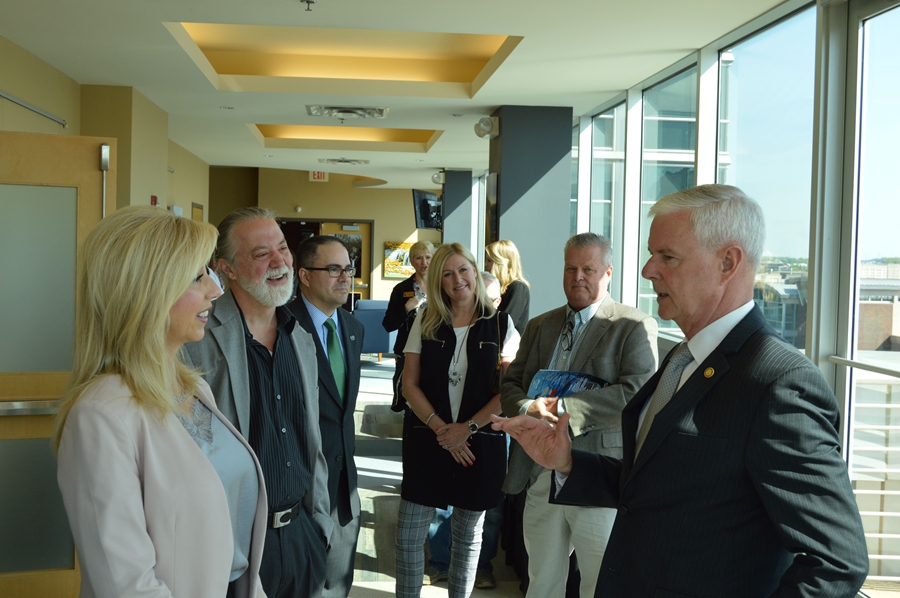 Rep. Steve Womack visits with Tasha Sinclair of Lycus Ltd., Flip Kindberg of SkyGenie and Steve Cherry of Kanooler Products before the trade briefing at the World Trade Center Arkansas in Rogers.
