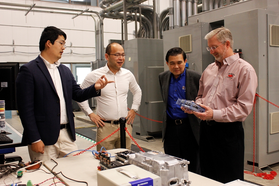 From left, NCREPT researchers Yue Zhao, Fang Luo, Simon Ang and Alan Mantooth inspect equipment inside the National Center for Reliable Electric Power Transmission. The researchers, along with Juan Balda (not pictured), are developing high power-density traction drives for hybrid and electric vehicles.