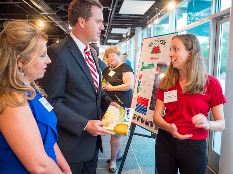 Shelley and Doug McMillon, left, chat with a student at a visit to the McMillon Innovation Studio.