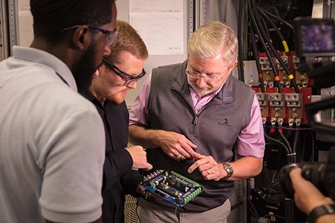 Alan Mantooth, right, Distinguished Professor of electrical engineering, with students at the National Center for Reliable Electric Power Transmission. 