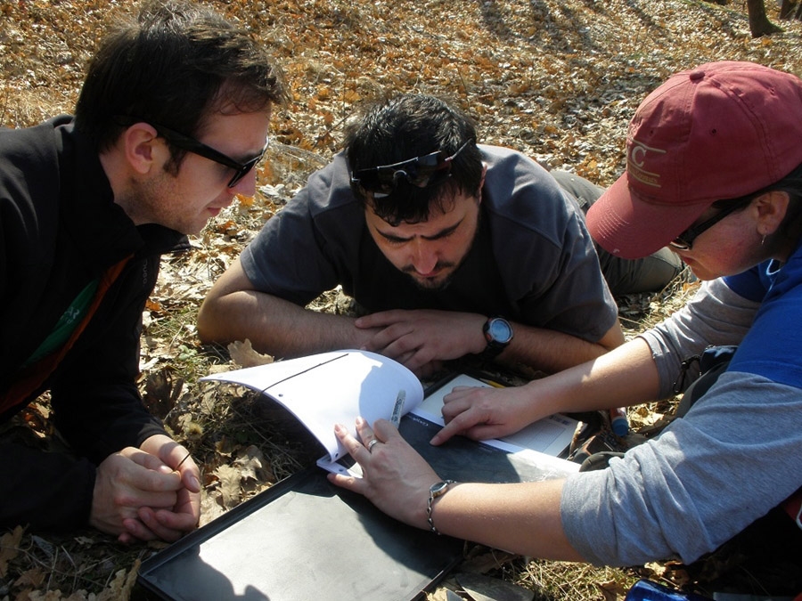 Prior to the COVID-19 pandemic, research team members Marius Robu, Alexandru Petculescu and Claire Terhune discuss where to look for fossils in the ?Oltet River Valley.