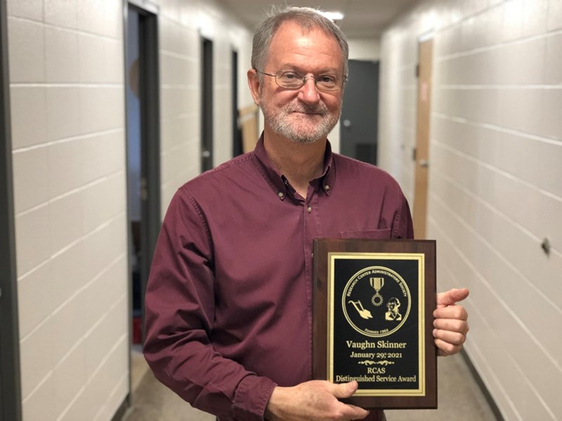 Vaughn Skinner, director of the Milo J. Shult Agricultural Research and Extension Center, with his 2021 Distinguished Service Award from the Research Center Administrators Society.
