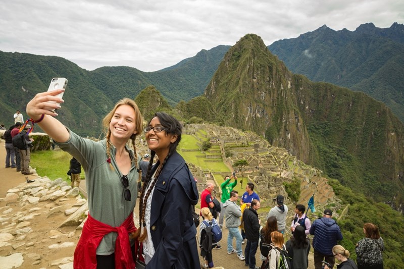 Students pose for a photo at Machu Picchu during the Honors College H2 Passport Study Abroad program in Peru.