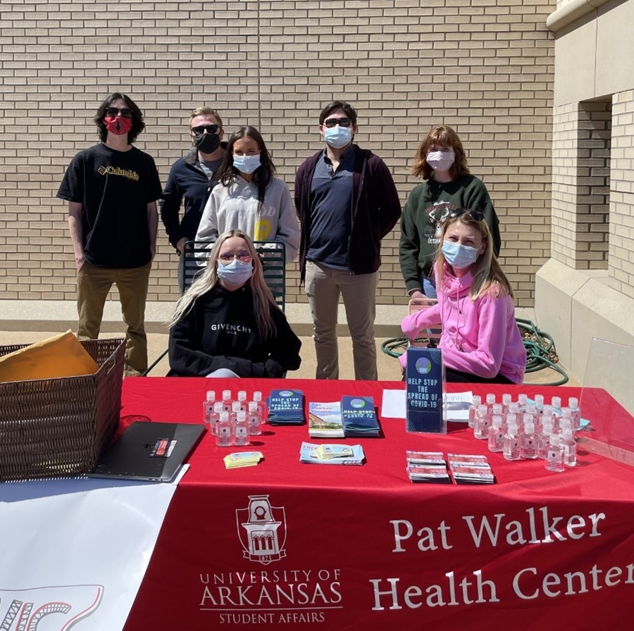 Students promote the #HandsFaceSpace Covid Challenge and vaccination station at the Arkansas Union.