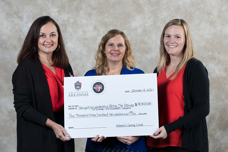 Kelly Chaney, president of the Women's Giving Circle, presents a check to Casandra Cox (middle) and Hanna Estes (right), both AECT instructors, accepting funding from the Women's Giving Circle to fund their project titled "Navigating Leadership Paths: The Stories of Diverse and Successful Leaders."
