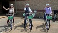Left to right: Reese Brewer, executive director of the Frontier Metropolitan Planning Organization; George McGill, Fort Smith mayor; and Suman Mitra, U of A assistant professor of civil engineering, try out bicycles available as part of the RIDE 4 SMILIES bike sharing project.