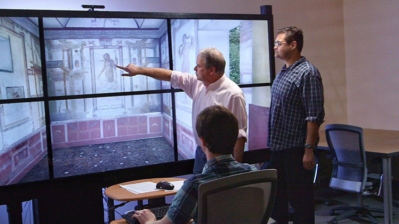 Associate professor David Fredrick points to a digitally recreated classical space designed for immersive education. Fredrick and music professor Stephen Caldwell have been named the inaugural recipients of the Paul Cronan Technology Teaching Excellence Award.