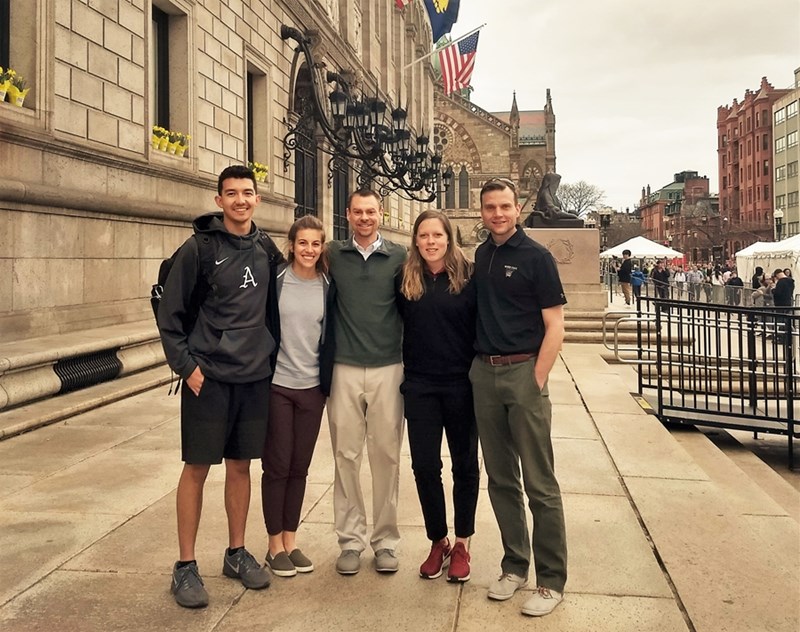 Associate professor Brendon McDermott (middle) with athletic training students at the 2019 Boston Marathon. McDermott has served as a heat illness expert and researcher on the race's medical team for many years.