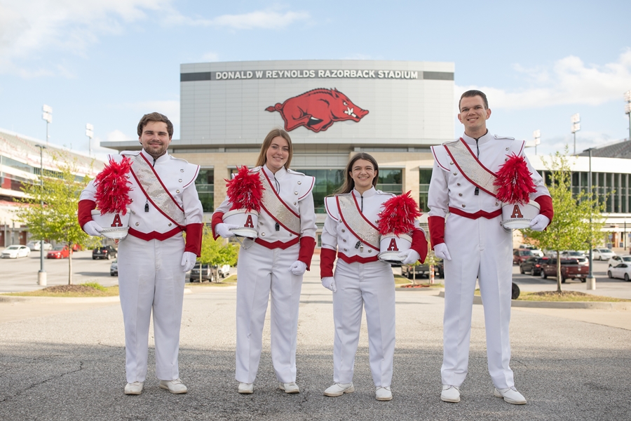 From left: Doug Harnish, Jenna Wheeler, Sallie Hendrix (head) and William Rowe, the drum majors of the Razorback Marching Band for the 2022-23 school year.