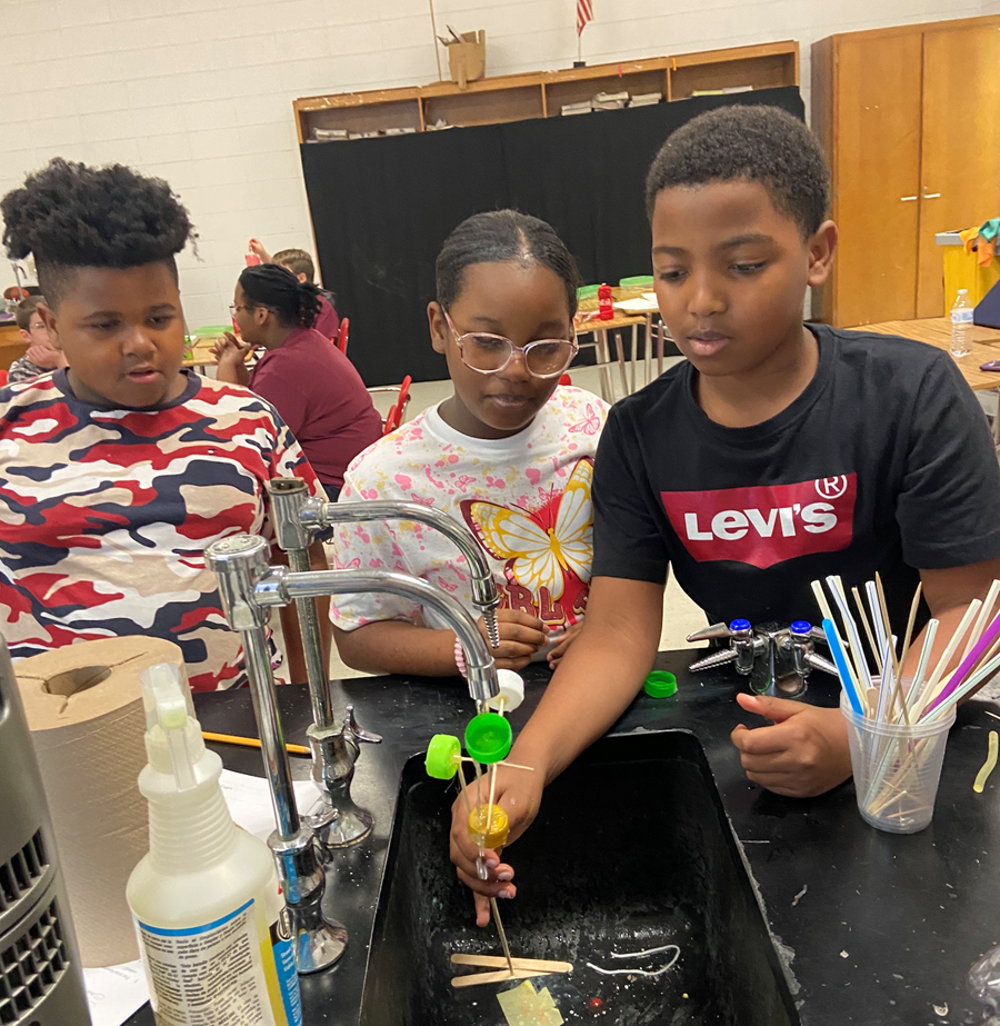 Students at Inside Engineering Summer Camp in Camden work as a team to create a water mill using recycled materials.