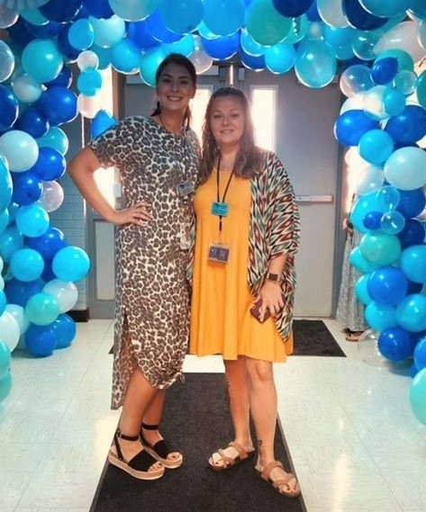 Julie Clift, left, was among the first to enroll in a new College of Education and Health Professions program that offers paraprofessionals the opportunity to earn a Bachelor of Science in Education degree online so they can remain in their hometowns. She's pictured with fellow paraprofessional Ashley Watkins on the first day of fall classes at the local elementary school.