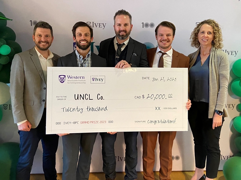 New Venture Development mentors and UNCL team members pose with their prize money at the Ivey Business Plan Competition in Ontario, Canada. From left: David Hinton, Michael Burton, Clayton Woodruff, Peyton Lentz and Sarah Gorfors.