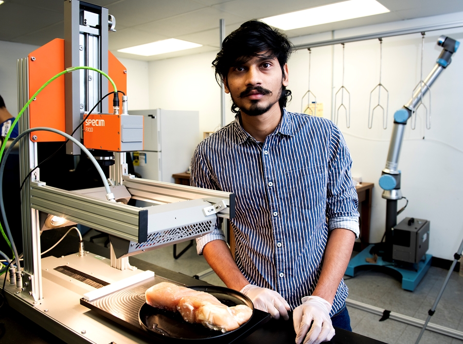 Graduate assistant Chaitanya Kumar Reddy Pallerla investigates the use of hyperspectral imaging to detect a defect in chicken meat.