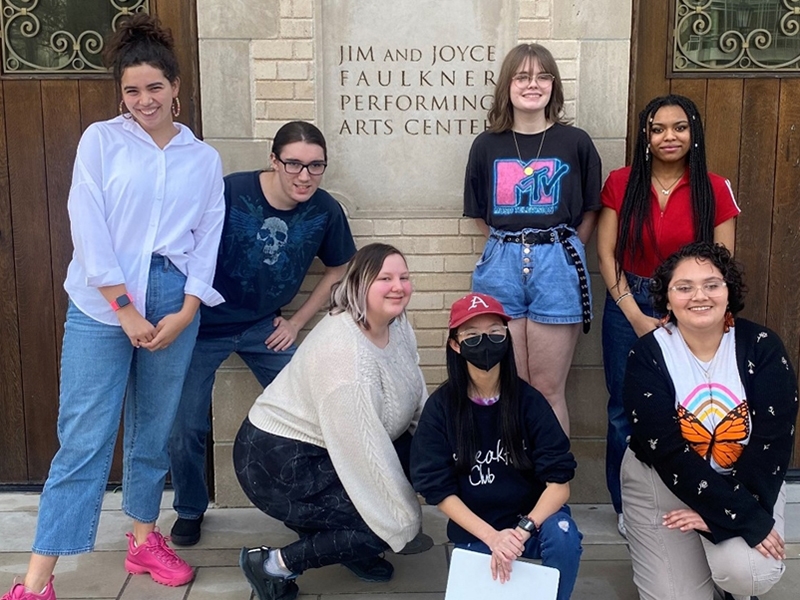 Maggie Smith, U of A Mentors, and ART/Works! Interns Draven Fields, Bug Nesbitt, Sophia Condray, Mullen Park, Siberia Hull, and Valeria Salto standing outside the Faulkner Performing Arts Center on February 20, 2023.