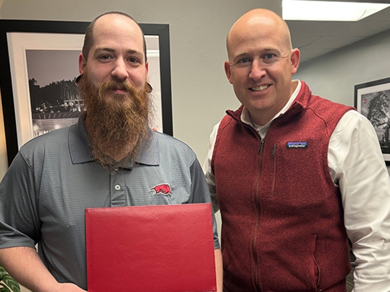 (l-r) Vinnie Modderman is congratulated by Interim Dean Brent Williams. Modderman is the employee of the first quarter for Walton College.