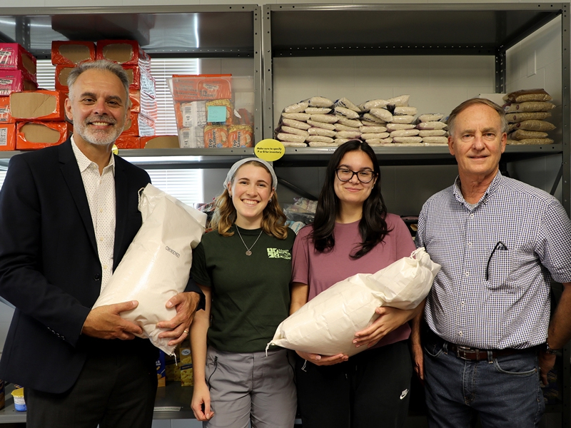 Bumpers College interim Dean Jean-Francois Meullenet (far left) with two student volunteers, Katelyn Helberg and Caroline Wilson, and Nathan McKinney, associate vice president of the Arkansas Agricultural Experiment Station, for the intake of rice donations to the pantry.